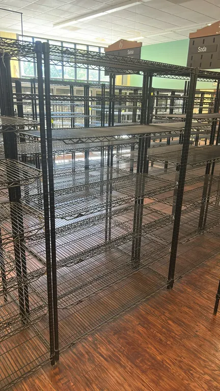 Metro multi-tier wire shelving racks. Features black wire construction with adjustable shelves and tubular upright posts. Dimensions: 48" x 18".