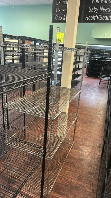 Metro 4-tier wire shelving rack. Features adjustable metal wire shelves and (4) upright posts. Dimensions: 48" x 24". Note: Heavy rust and corrosion t