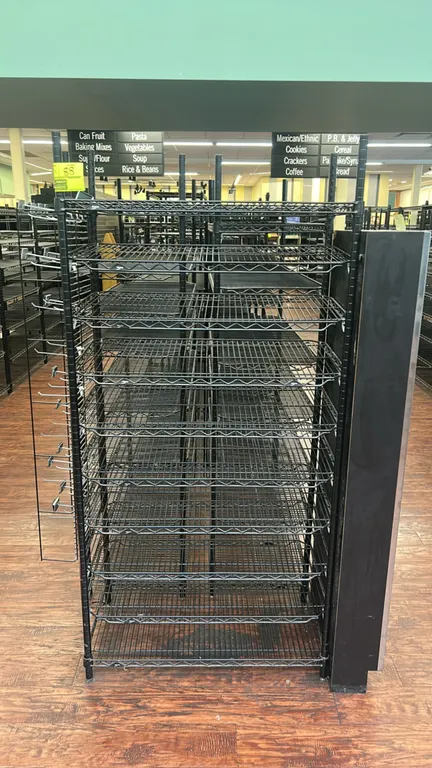 Metro multi-tier wire shelving racks. Features black finish, adjustable wire shelving tiers, and side-mounted wire grid display panels with hooks. Dim