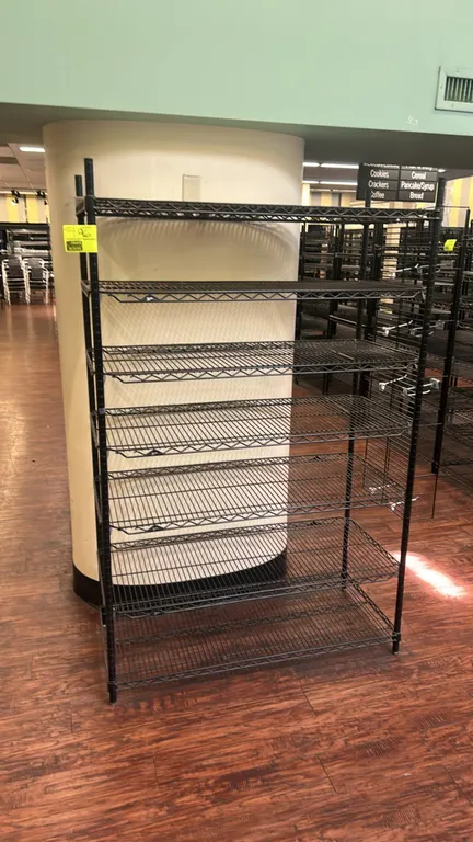 Metro 7-tier metal wire shelving rack. Features adjustable black wire shelves and (4) upright posts with leveling feet. Dimensions: 48" x 18".