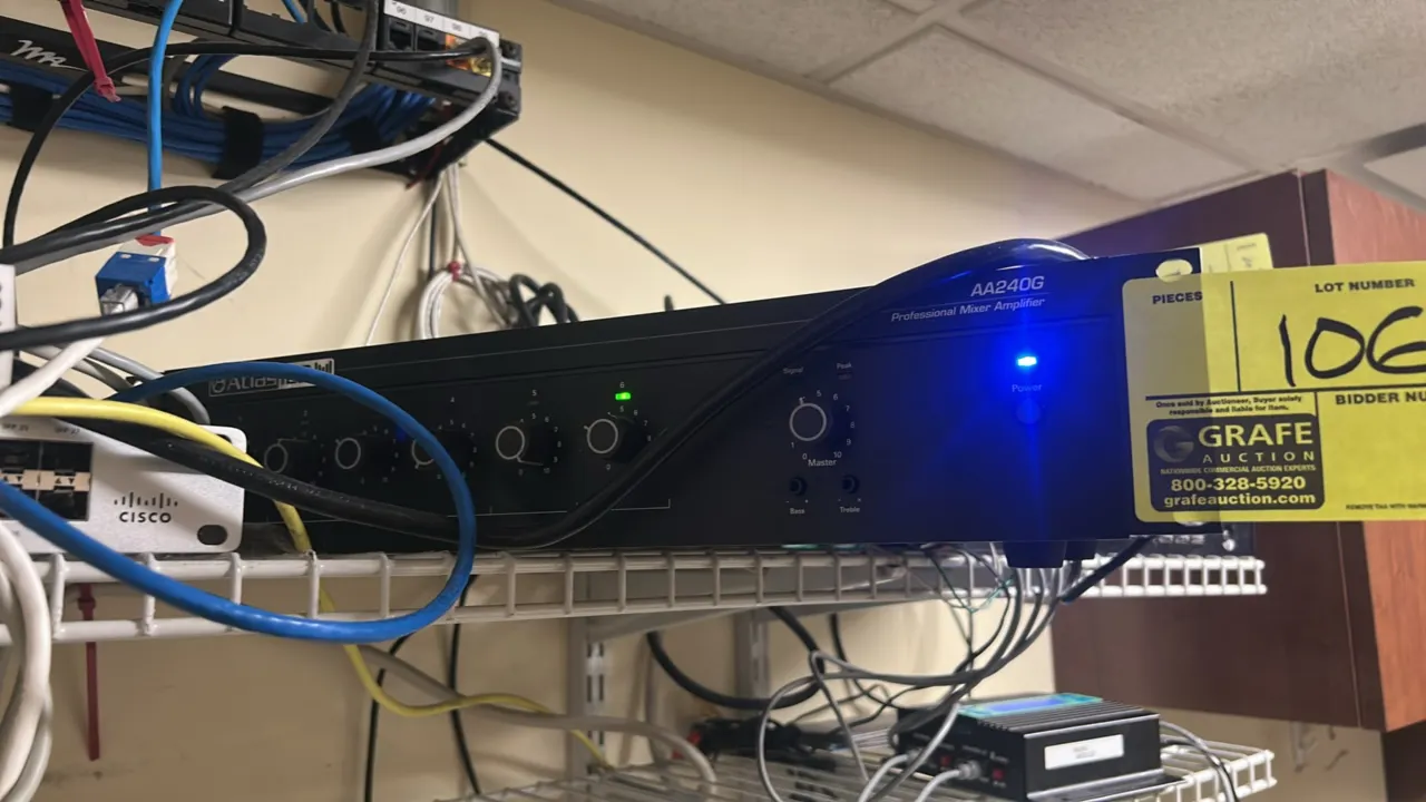 AtlasIED AA240G commercial mixer amplifier. Features 6 input controls, master volume knob, bass and treble controls, and LED status indicators. Rack-m