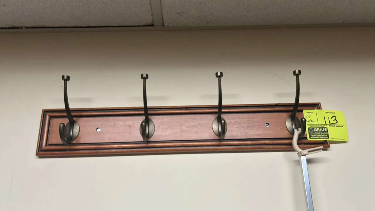 Wall-mounted wooden coat rack and cork bulletin board. Coat rack features a finished wood backer with (4) metal double hooks. Includes a wood-framed c