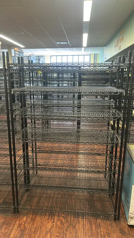 Metro metal wire multi-tier shelving racks. Features black wire construction, multi-tier adjustable wire shelves, and upright support posts. Dimension