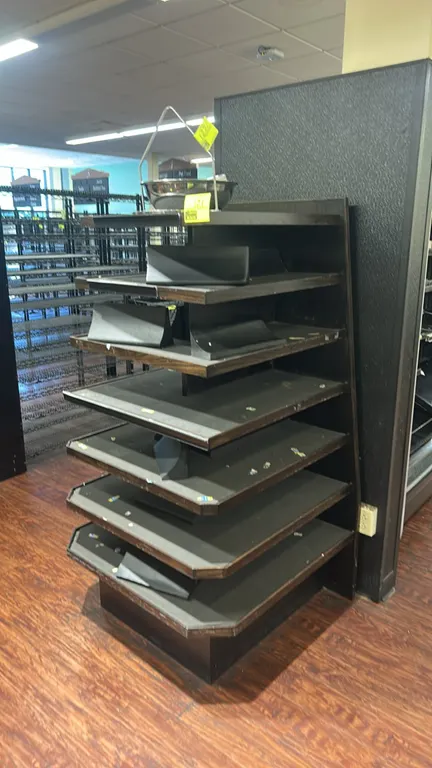 Laminate multi-tier produce merchandiser. Features tiered display shelving with dark woodgrain finish and front lip shelf retainers. 36" x 36". Note: