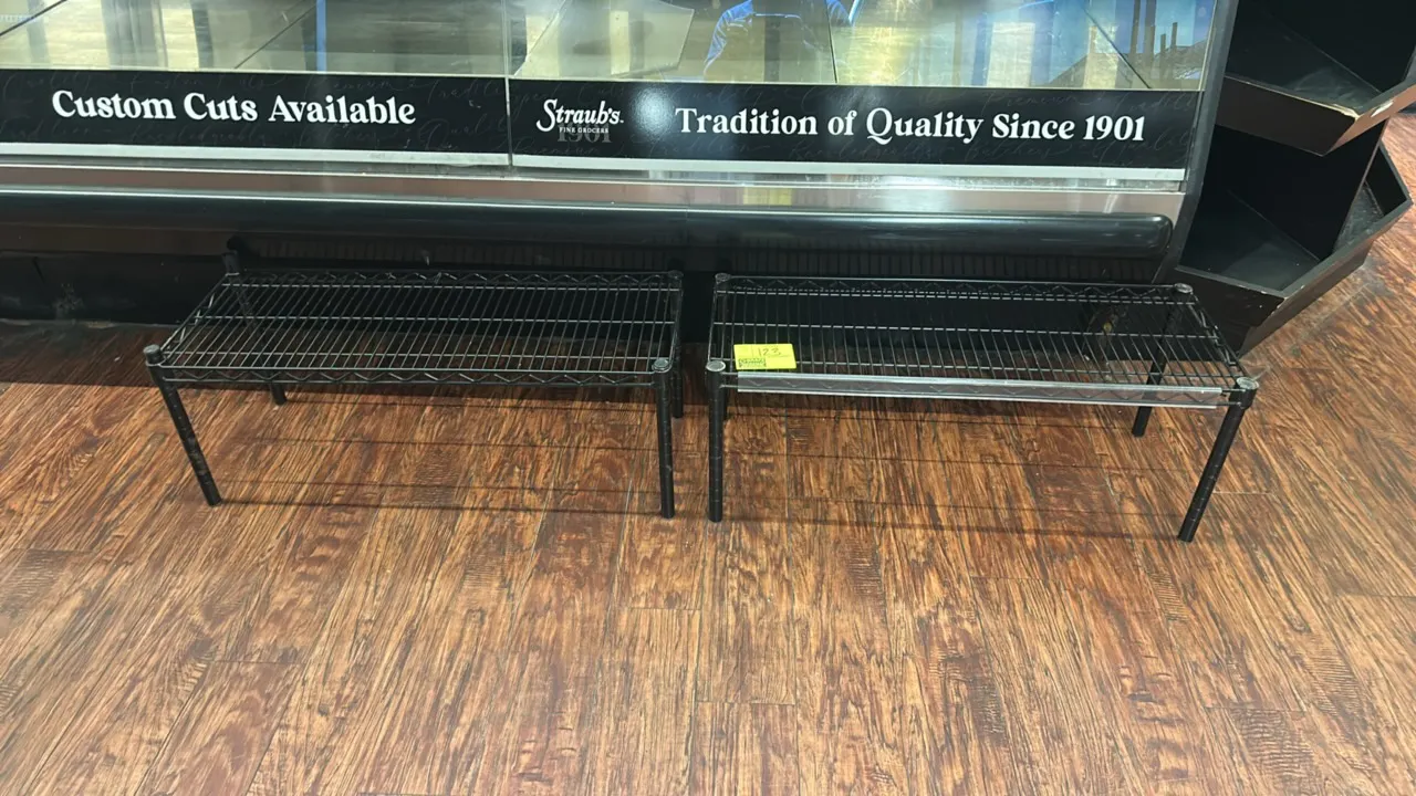 Metal wire display racks. Features black-coated wire construction and stationary post legs. One unit includes a front ticket molding channel strip. Di