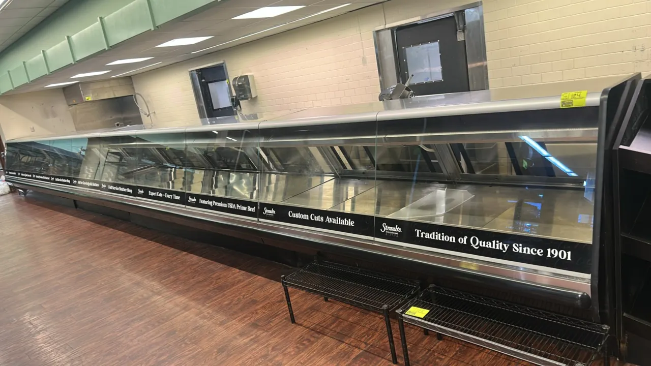 2015 Hussmann ESGMVS-8 slant glass medium-temp service display cases. Features slant front glass, sliding rear doors, fold-down cutting boards, and st