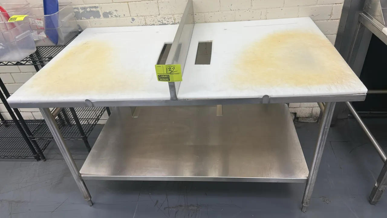 Stainless steel prep table. Features poly cutting board top with cutouts, center stainless steel divider, and stainless steel undershelf. 5' x 3'. Mou
