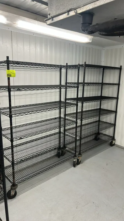 Metro multi-tier portable wire shelving racks. Features (6) adjustable wire shelves in a black finish. 48" x 18". Mounted on swivel casters.