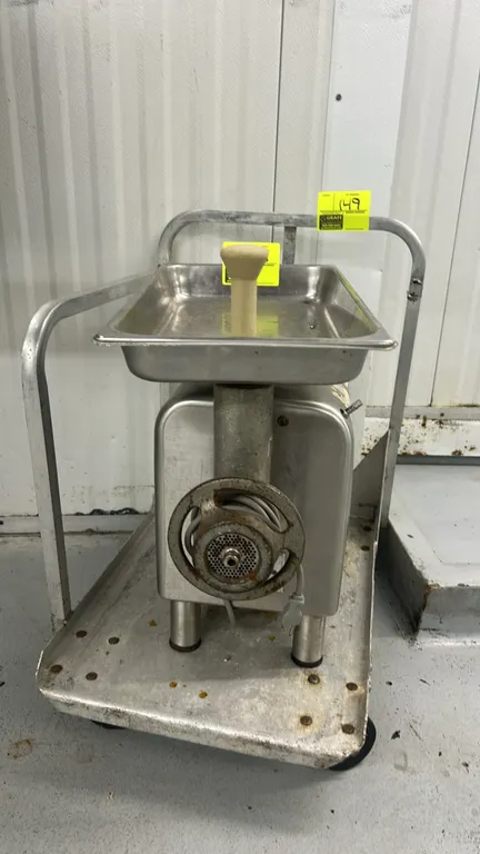 Hobart 4812 commercial meat grinder. Features stainless steel housing, feed pan, stomper, and grinder head assembly. S/N: 56-1247-450. Electrical: 100