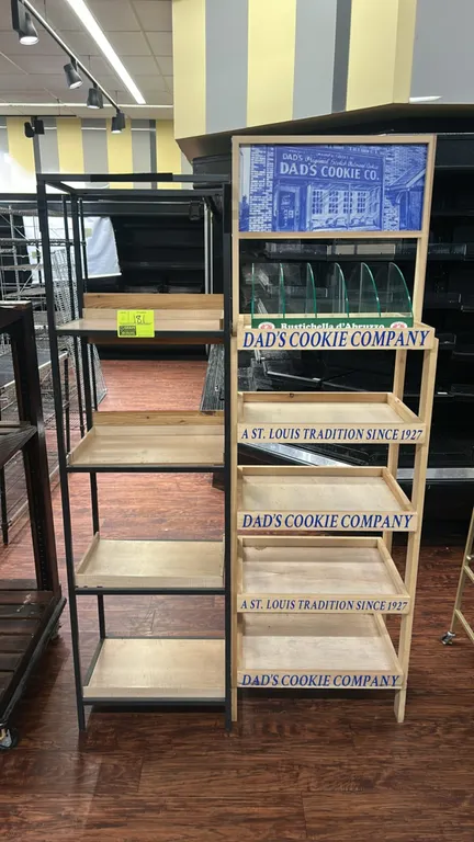 Multi-tier merchandiser display racks. Includes one black metal frame unit with (4) wood tray shelves, and one wooden 5-tier display unit featuring Da