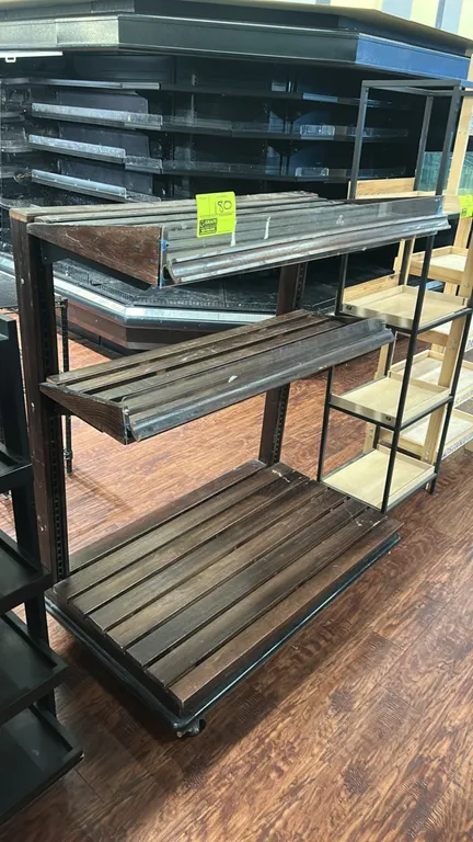 Wooden 3-tier portable merchandiser. Features dark-stained slatted wood construction, 2 adjustable angled upper shelves with clear acrylic front retai