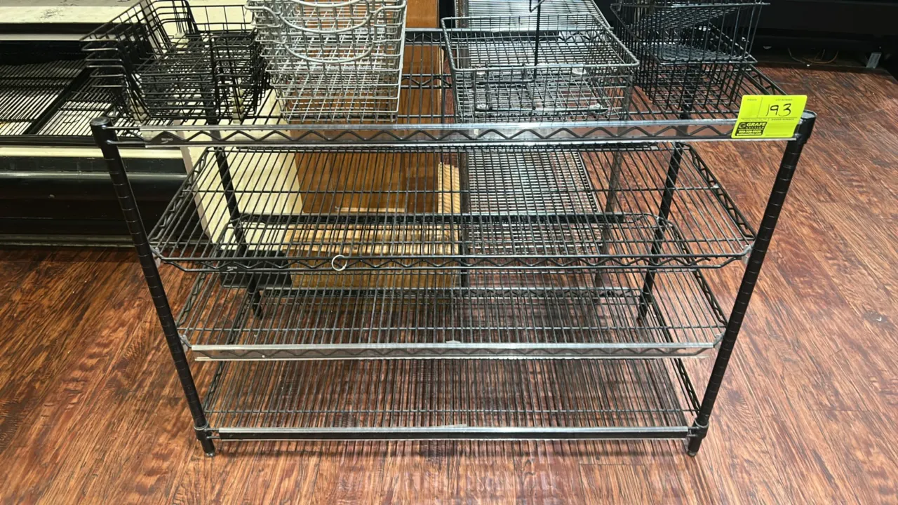 Metro wire multi-tier display rack. Features black finish, (4) wire shelves including slanted tiers, and shelf label holders. Dimensions: 48" x 21". C
