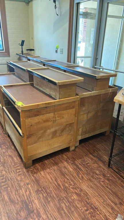 Wooden 3-tier merchandisers. Features tiered display shelves with edge lips, integrated front shelf trim channels, and paneled wood bases. 36" x 30".
