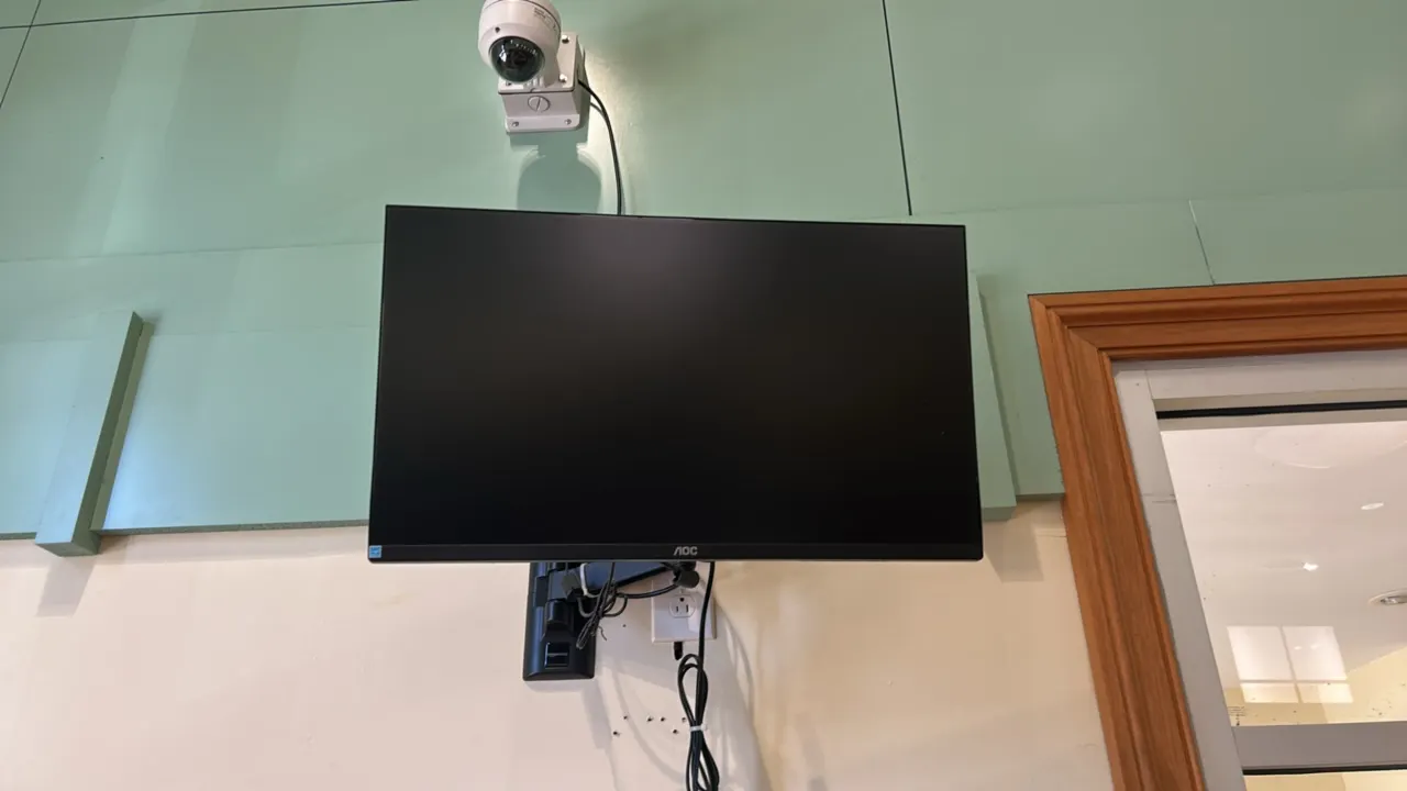 AOC 32" flat panel monitor. Features thin bezel design. Includes articulating wall mount bracket and power cord. Note: Security camera mounted above i
