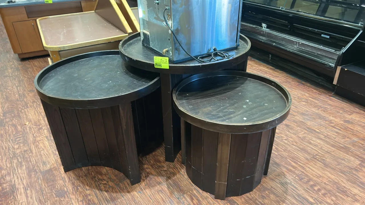 Wooden circular produce dump display tables. Features set of (3) tiered round merchandising tables with raised-lip tops and dark-finished vertical woo
