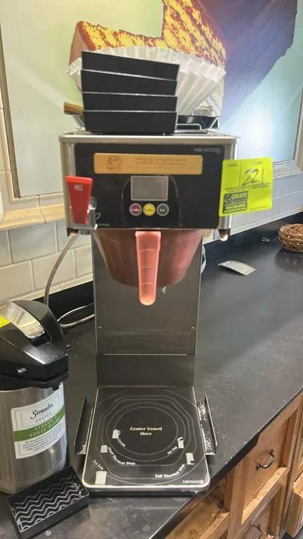2004 Newco GXF-P TVT stainless steel commercial coffee brewer. Features hot water dispense faucet, digital display, push-button controls, brew basket,