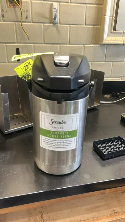 Wilbur Curtis ThermoPro 2.5-liter airpot. Features stainless steel body, lever-action dispenser, and carrying handle.
