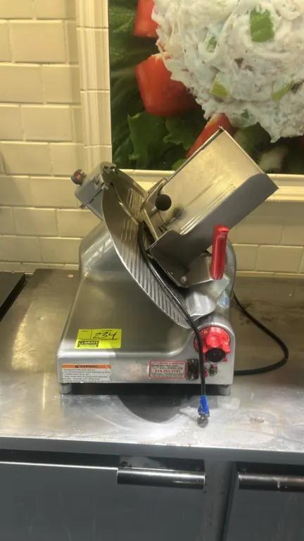 Berkel 919/1 meat slicer. Features gravity-feed product carriage, slice thickness control knob, and stainless steel construction. S/N: 9365-01111-1202