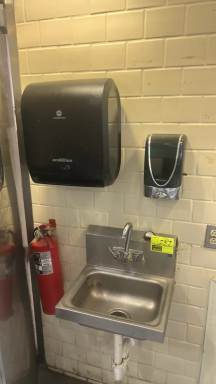 Stainless steel handwashing sink. Wall-mount design featuring integrated backsplash and splash-mount gooseneck faucet with dual lever handles. Include