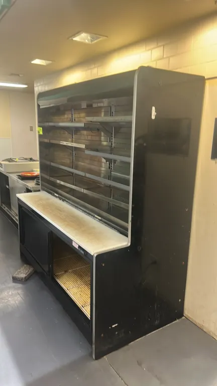 Hussmann remote multi-tier deli display case with refrigerated undercounter. Features stainless steel interior, multi-tier adjustable shelving, poly t