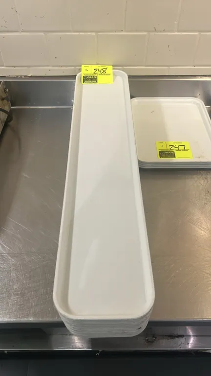 Poly display trays. Features white molded plastic construction with raised rim edges. 30"L.