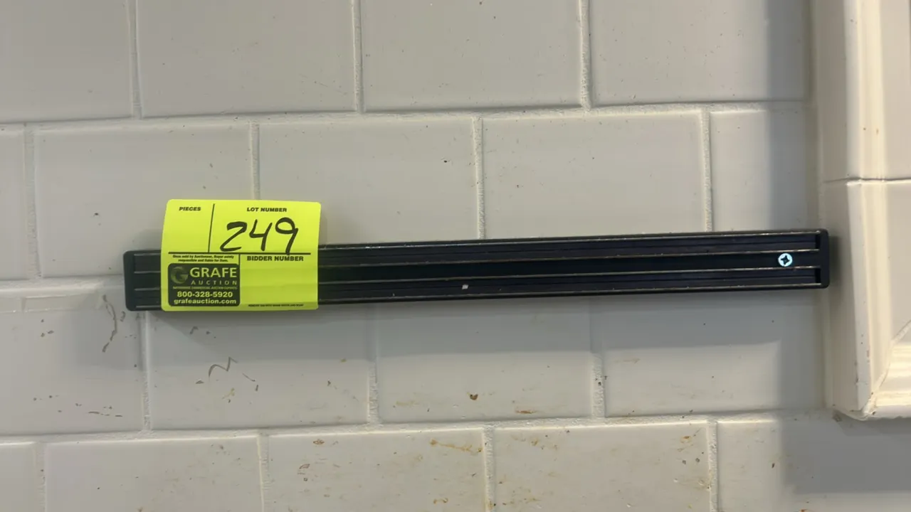 Magnetic knife bar. Features dual magnetic strips in a black casing. Wall mounted.