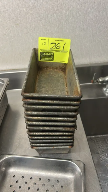 Metal loaf pans. Features folded corner construction, wire-reinforced rims, and nesting design for storage. 10"L.