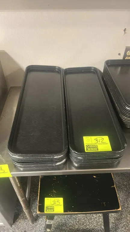 Black poly display trays. Features a rectangular design with raised edges for food service or retail display. 25" x 9".