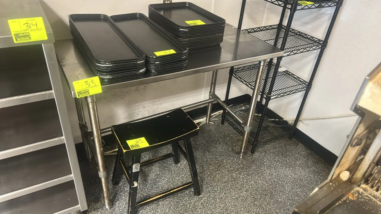Stainless steel work table. Features a flat top, tubular legs, and rear and side cross bracing. 4'L x 2'W. Mounted on adjustable bullet feet. Trays an