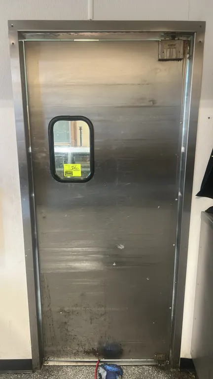 Eliason stainless steel swing door. Features integrated viewing window, Eliason top pivot hinge hardware, and frame. 35" x 82".