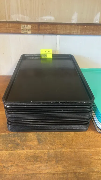 Full-size poly trays. Features black molded construction with raised edges and stackable design. Adjacent trays not included.
