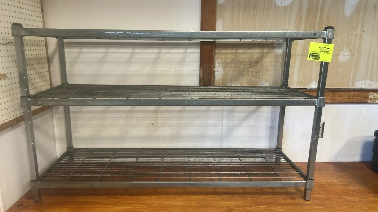 Metal 3-tier wire storage rack. Features (3) wire grid shelves and square upright posts. Dimensions: 54" x 18".