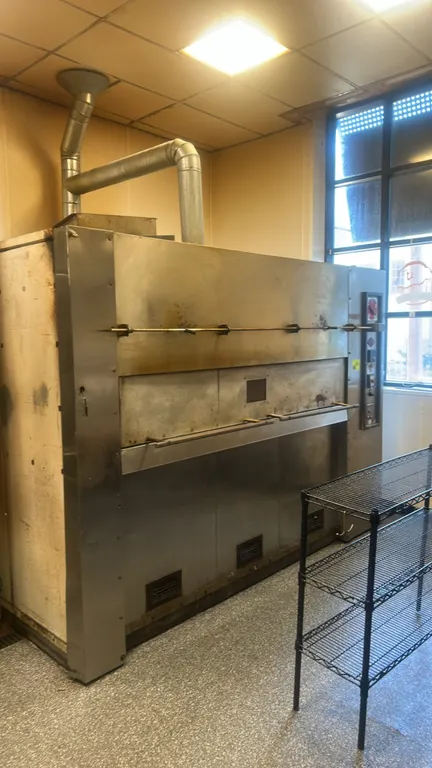 Reed commercial revolving bakery oven. Features stainless steel construction, 25-count capacity revolving wire shelves, digital temperature controller