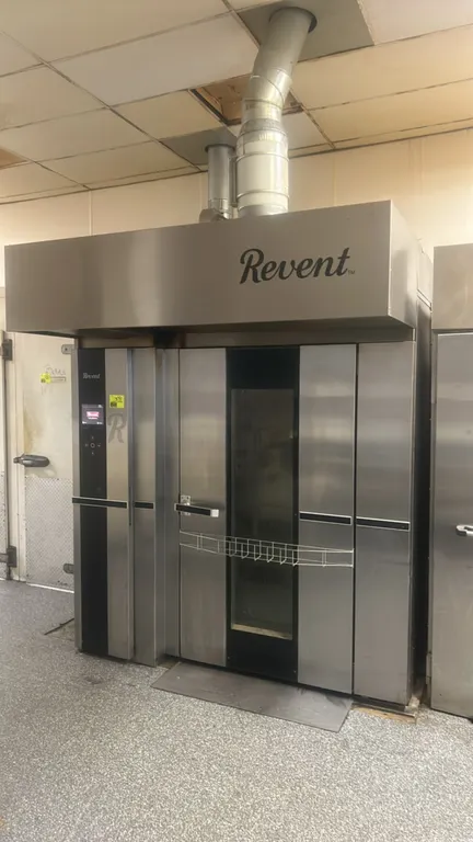 Revent 724 G CG U stainless steel double rack natural gas rotating rack oven. Features top-mounted stainless steel exhaust hood, digital touchscreen c
