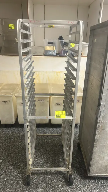 Aluminum full-size front-load sheet pan rack. Features 20-tier pan slides. Mounted on swivel casters.