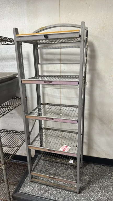 Pepperidge Farm 5-tier metal merchandiser display rack. Features wire shelves with integrated front price tag channels and arched top header frame. 58