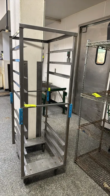Stainless steel front-load speed rack. Features angle pan slides and open-frame construction. Mounted on swivel casters.