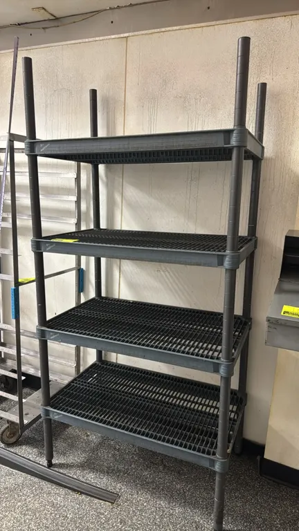 Metro 4-tier polymer shelving rack. Features four vented grid shelves and adjustable posts. 36" x 18" x 73". Leveling feet.