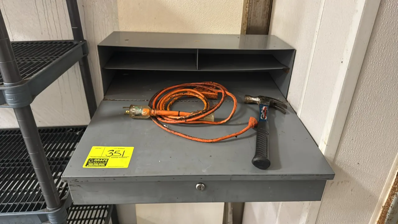 Metal wall-mount receiving desk. Features upper sorting shelf compartments, lockable compartment, and gray painted finish. Includes claw hammer and ex