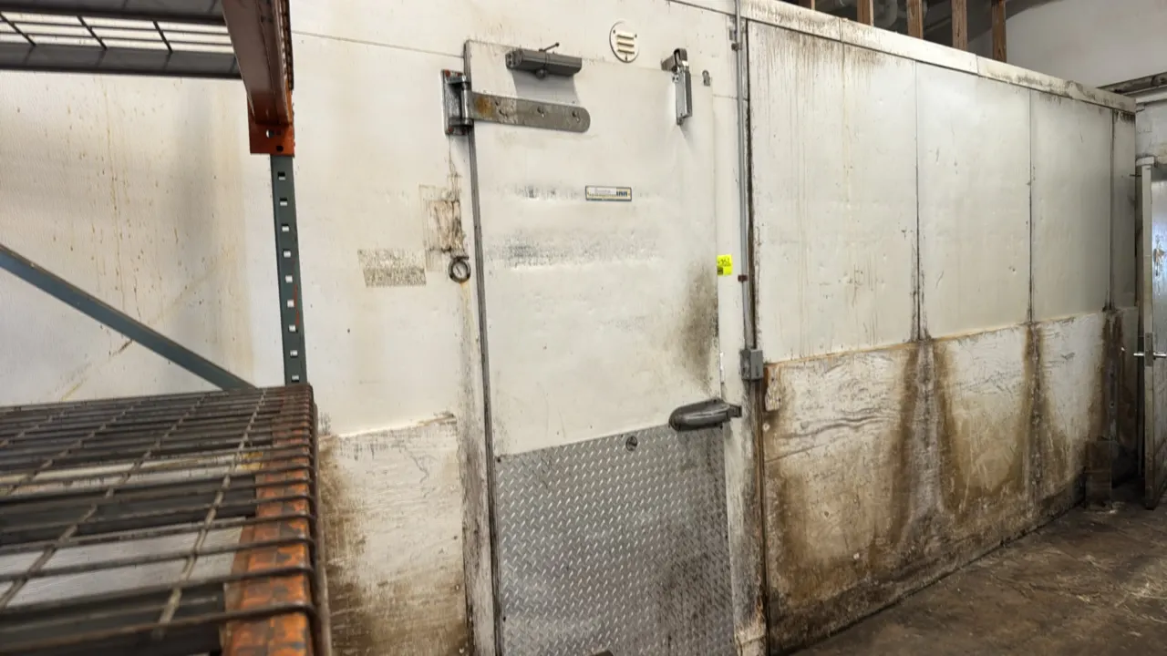 Hussmann foam panel walk-in freezer. Features pallet door, entry door, evaporator coils, and interior lighting. 30'L x 8-1/2'W x 8-1/2'H. Note: For re