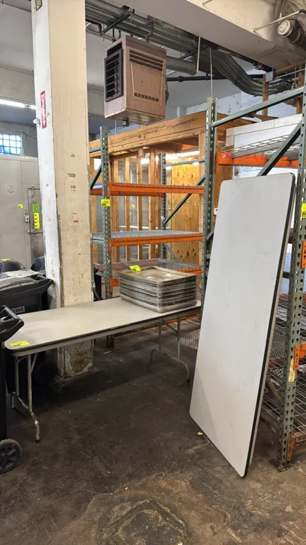 Laminate folding tables. Features gray laminate top surfaces with protective edge banding and folding metal wishbone legs. 72"L x 30"W. Contents not i