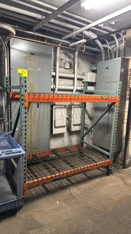 Interlake portable racking. Features teardrop style uprights, two shelf tiers with orange step beams, and wire mesh decking. 60" x 36" x 66". Mounted