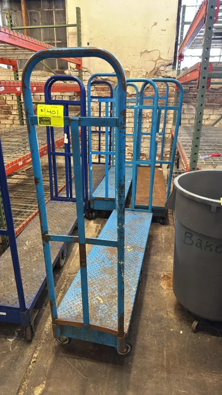 Metal U-boat platform carts. Features light blue finish and tubular steel end handles. 5'L. Mounted on casters.