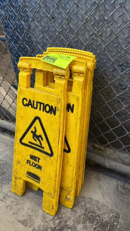 Rubbermaid Commercial Products folding wet floor signs. Features yellow polypropylene construction, two-sided 'CAUTION WET FLOOR' hazard warning messa