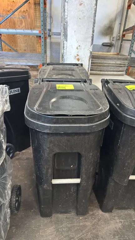 Rehrig Pacific HuskyLite ROC-35EG poly rollout trash cans. Features 35-gallon capacity, attached hinged lid, molded rear handle, front lift bar, and U