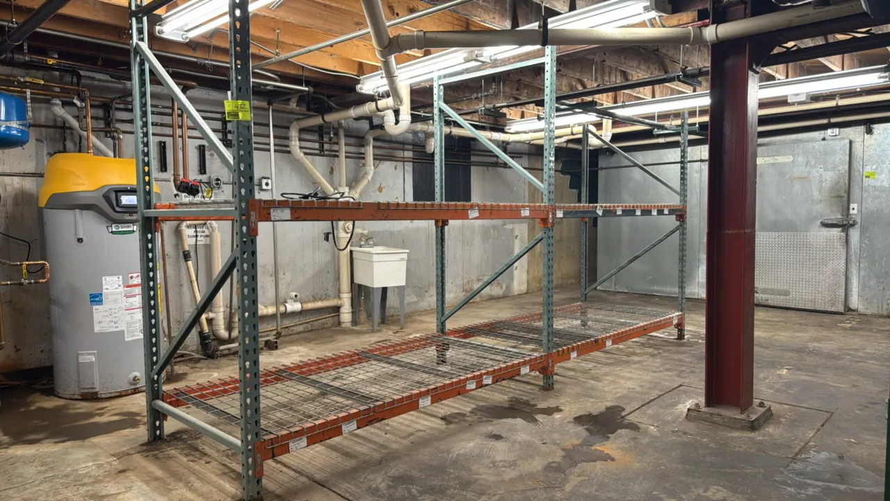 Interlake pallet racking. Features 8' sections, wire metal decking, and teardrop uprights. Uprights measure 4' x 9'. Background items not included.