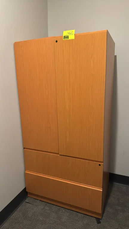 Wood laminate storage cabinet. Features upper 2-door cabinet compartment with 2 interior shelves and 2 lower lateral file drawers. Natural woodgrain f