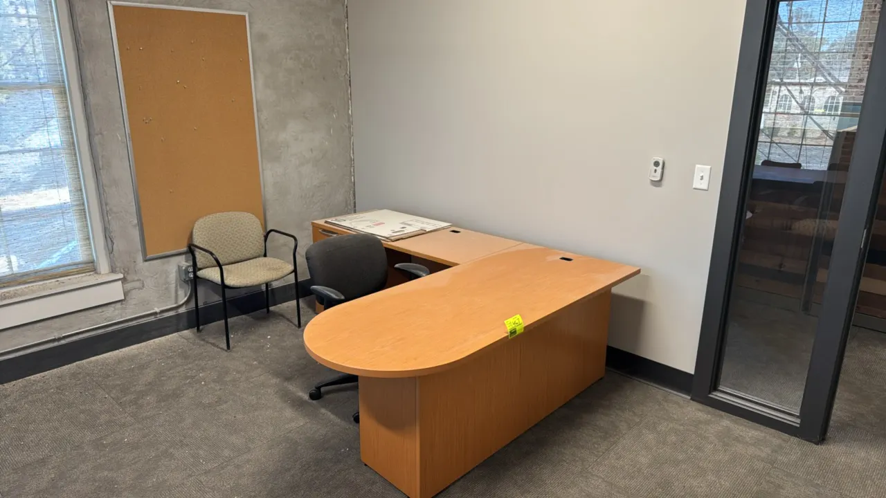 Knoll L-shaped office desk suite. Includes 6' x 7' L-shaped desk, rolling office task chair, stationary armchair, and wall-mounting cork bulletin boar