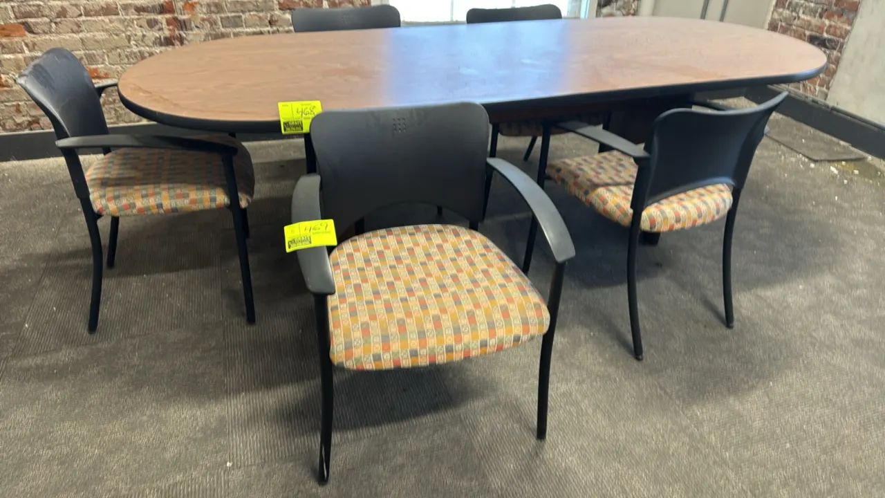 Teknion upholstered armchairs. Features black molded plastic backs, multicolored patterned fabric padded seats, integrated armrests, and black metal 4