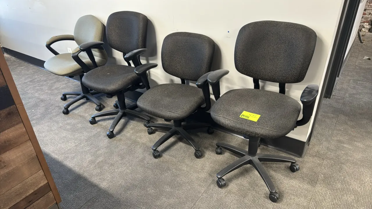Upholstered office chairs. Features padded fabric seats and backrests, armrests, and 5-star swivel bases with casters. Assorted styles and upholstery